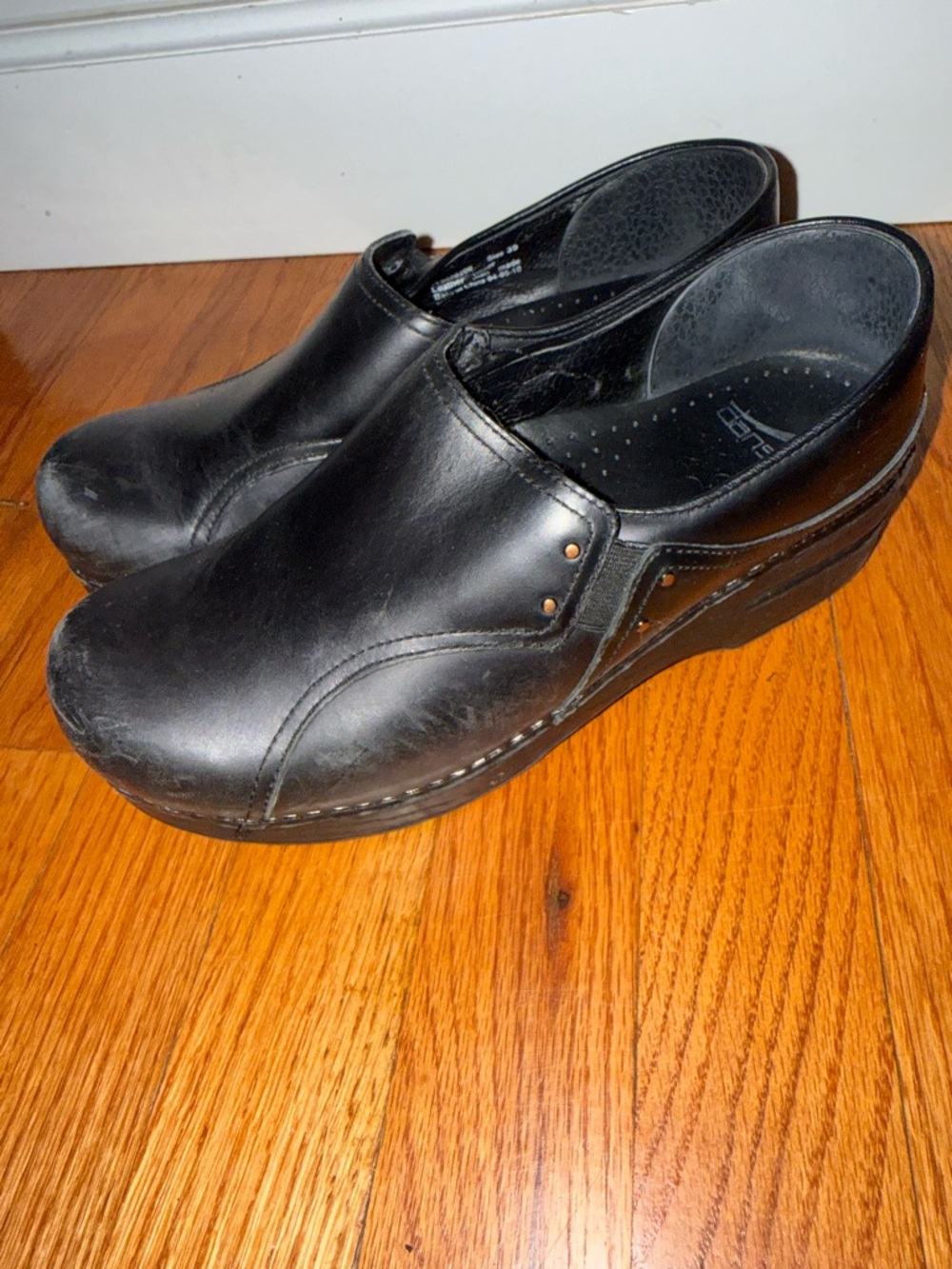 Dansko Phoebe closed-back black leather slip-on clogs